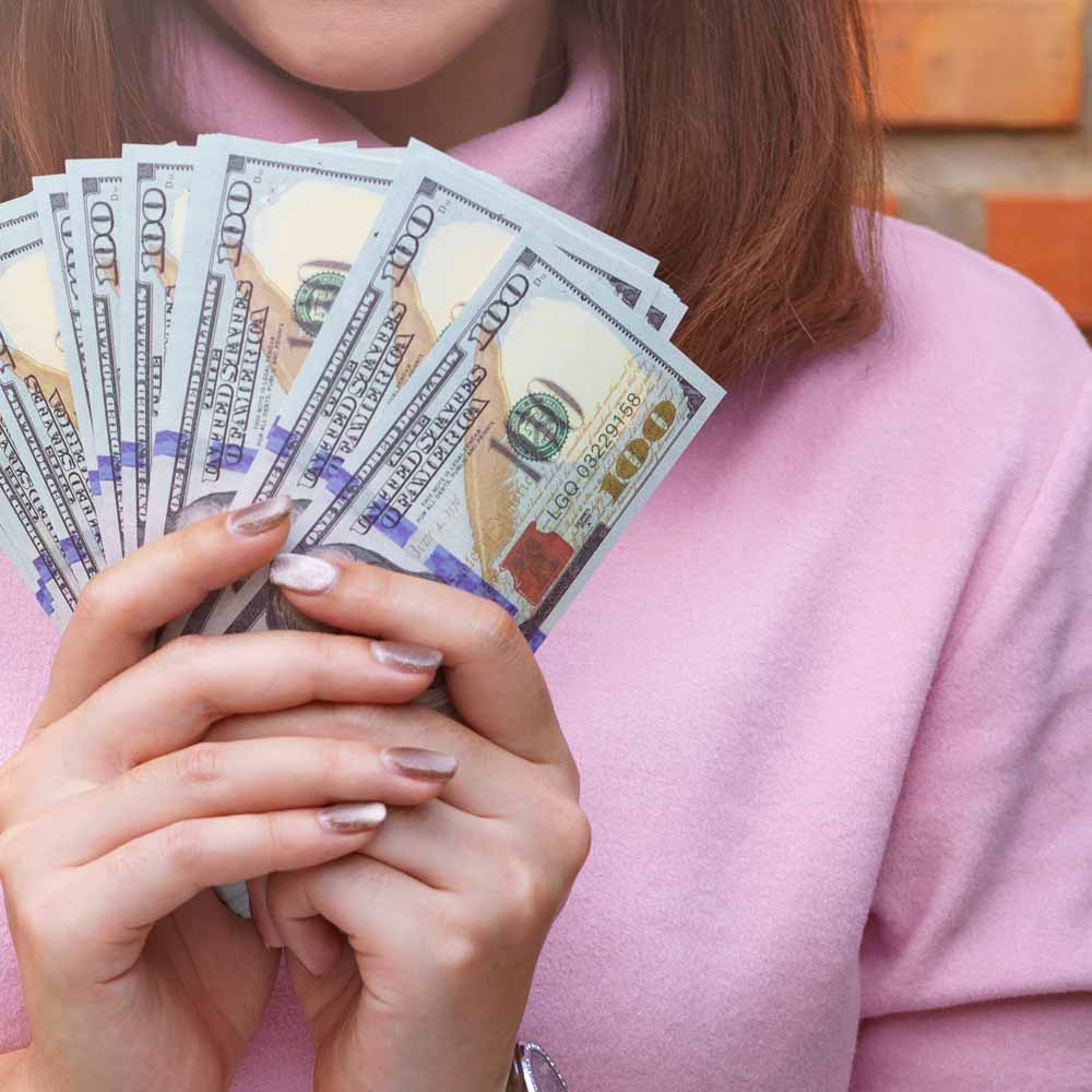 female-holding-money Close up of woman holding money